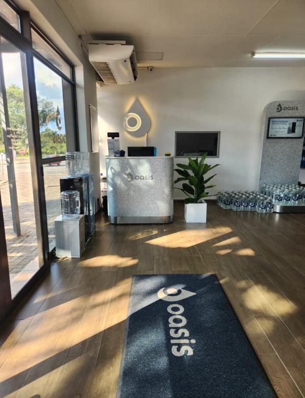 Oasis store with branded counter and mat